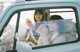 A couple of women sitting in the back seat of a car.