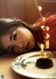 A woman laying on a table next to a plate of food.